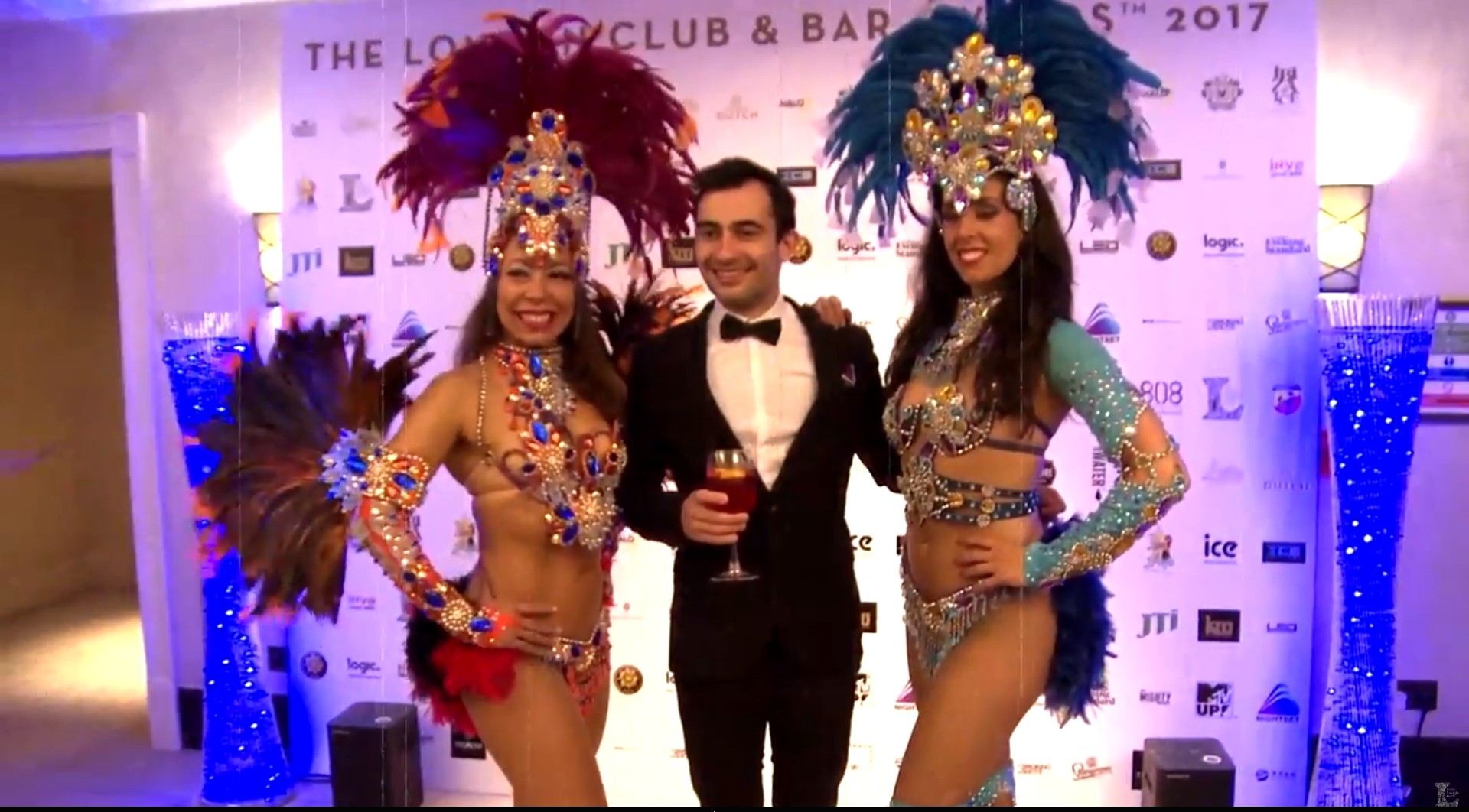 At The London Club & Bar Awards 2017, flanked by samba dancers, holding a cocktail like it owes me money.